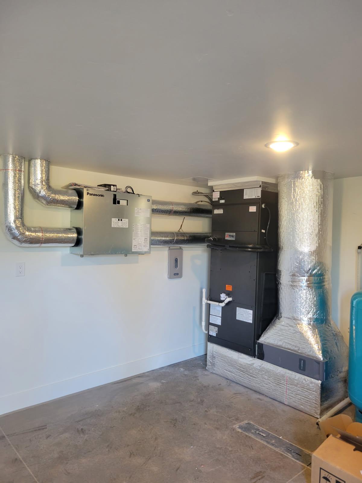 Finished indoor HVAC system with Mitsubishi air handler, Panasonic ERV, and insulated ductwork in Central Oregon