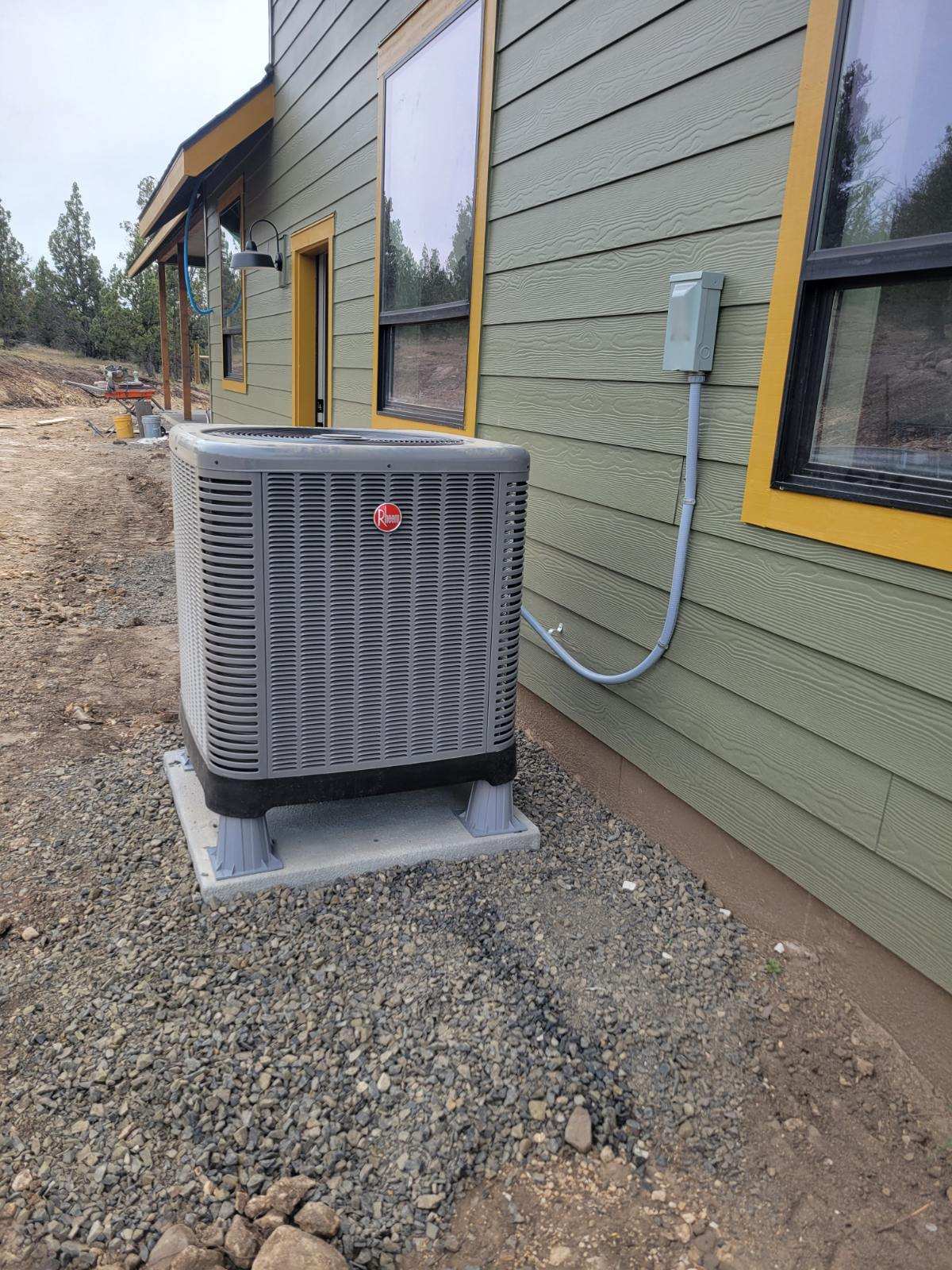 Rheem AC condenser unit installed beside a home in Bend, Oregon by Terra Heating and Cooling